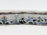 a small blue and white box with a bird on it