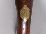 a wooden and brass vase with a bird on it