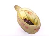 a small cup with a flower design on it