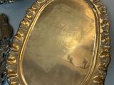 two silver trays and a silver spoon on a table