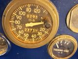 a close up of a clock on a blue wall