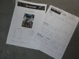 papers on the ground with a picture of a man in a box machine