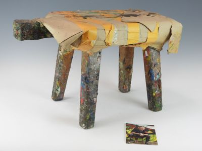 un petit tabouret en bois fabriqué à partir de bâtonnets de bois