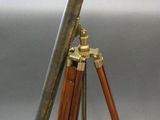 an antique telescope on a tripod with a wooden tripod stand
