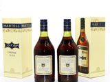 two bottles of martella and a box of wine on a white surface