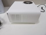 an image of a projector sitting on a desk next to a mouse