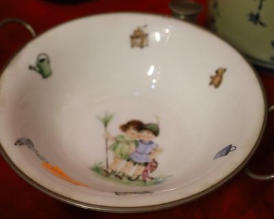 a white bowl with a picture of a boy and a girl on it