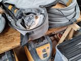 a pile of tools sitting on a table in a garage