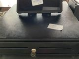 a black cash register sitting on top of a black table