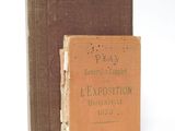 an old book sitting on top of a table next to a brown book