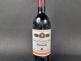 a bottle of red wine sitting on top of a table