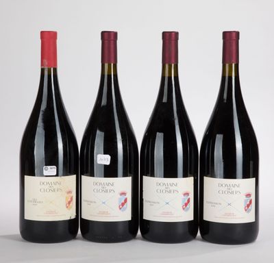 three bottles of red wine are lined up on a white surface