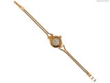 une image d'une montre-bracelet en or avec un cadran blanc