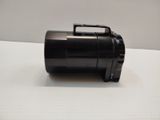 a small black object on a table with a white background