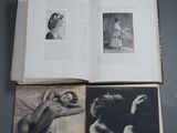 an open book sitting on top of a wooden table next to pictures