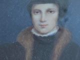portrait of a young man in a black coat and a brown hat