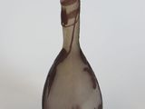 a glass vase that is sitting on a white surface