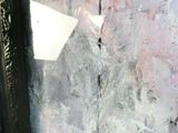 a piece of paper sticking out of a hole in the wall