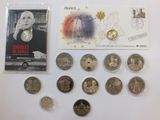 a lot of coins and a postcard on a table