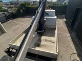 a crane that is sitting on the side of the road