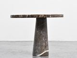 a close up of a table with a marble top on a concrete floor