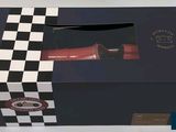 a black box with a red hair dryer inside of it