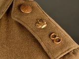 a close up of a military uniform with buttons on the collar