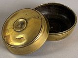 a small metal box with a lid on a table