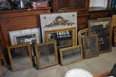 a lot of mirrors sitting on the floor next to a fireplace