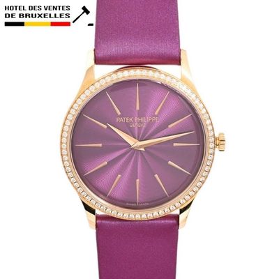 the watch is purple and gold with diamonds on the face