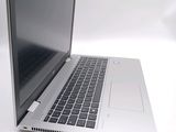 a laptop that is open on a white surface