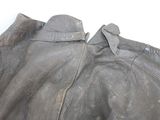 a close up of a leather jacket on a white surface