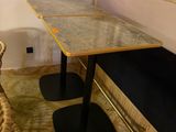 a table with two chairs and a bench in the corner