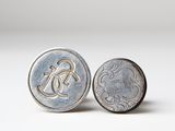 a close up of a coin and a coin on a white surface