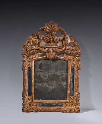 an ornately carved mirror in the shape of a frame with flowers and leaves on it