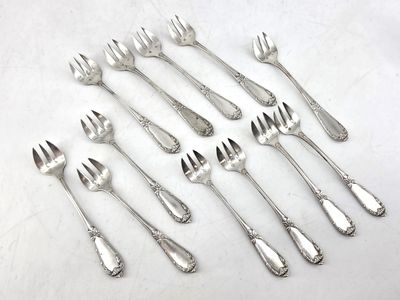 a lot of forks and spoons sitting on a table