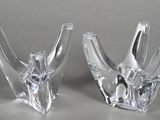 pair of clear glass vases sitting on top of a table