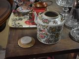a small table with a vase and other items on it