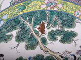 a painting on the wall of a building with a bear in a tree