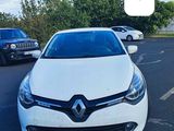 the white car is parked in the parking lot next to other cars