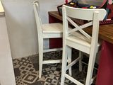 two chairs and a table with a suitcase on top of it