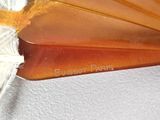 a close up of an orange glass fan on a white surface