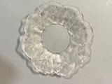 a clear glass object with a circular design on it
