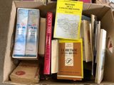 many books in a box that are sitting on the floor