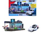 toy cars are parked in front of a bmw dealership