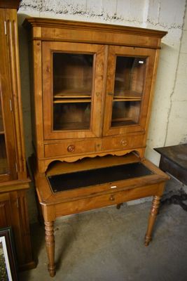 a wooden cabinet with a glass door on top of it