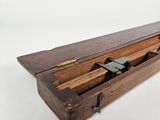 an old wooden box with a metal latch on top of it