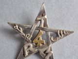 a close up of a metal star on a white surface