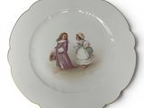 a white plate with a picture of a woman and a child on it