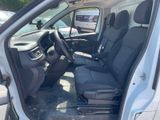 the interior of a car with the door open and the driver ' s seat down